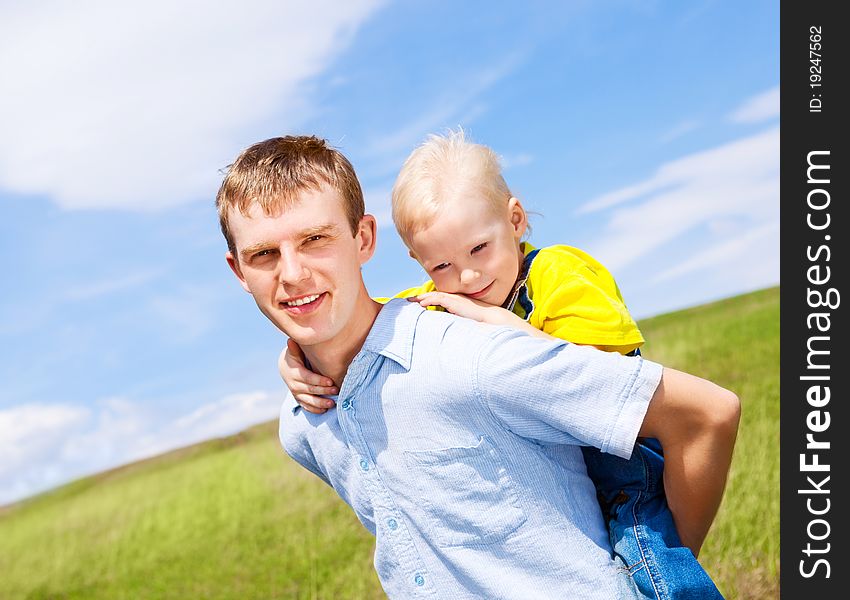 Happy father and his son with balloons outdoor on a summer day. Happy father and his son with balloons outdoor on a summer day