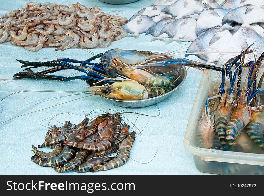 A display of fresh water prawn and white pomfret in a wet market. A display of fresh water prawn and white pomfret in a wet market