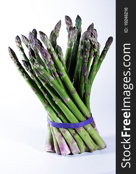 A bundle of asparagus isolated on a bright background