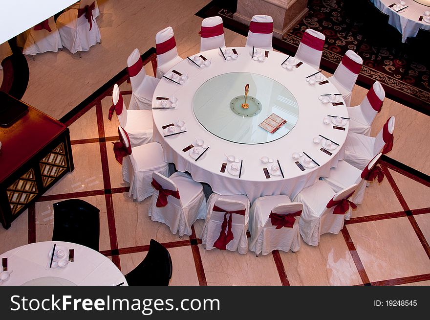 A top view of a round table in a restaurant with 15 seats. A top view of a round table in a restaurant with 15 seats.
