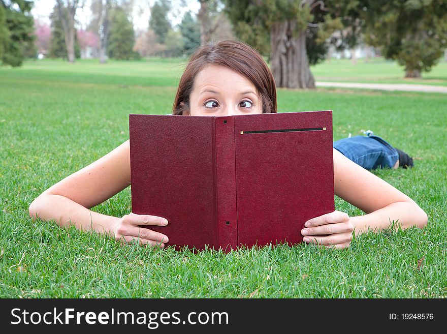 Young student with crossed eyes reading. Young student with crossed eyes reading