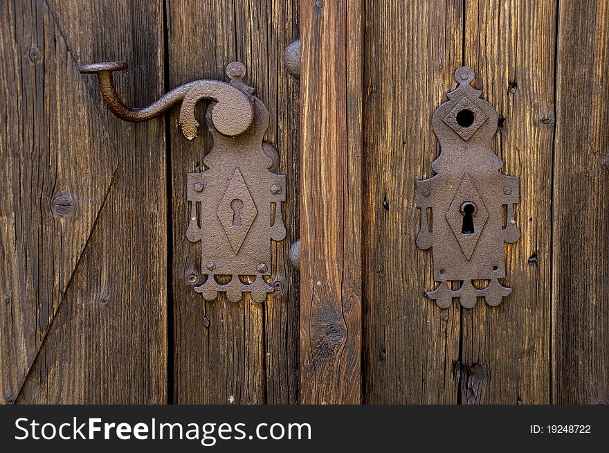 Rusty escutcheon plate on old wooden door. Rusty escutcheon plate on old wooden door