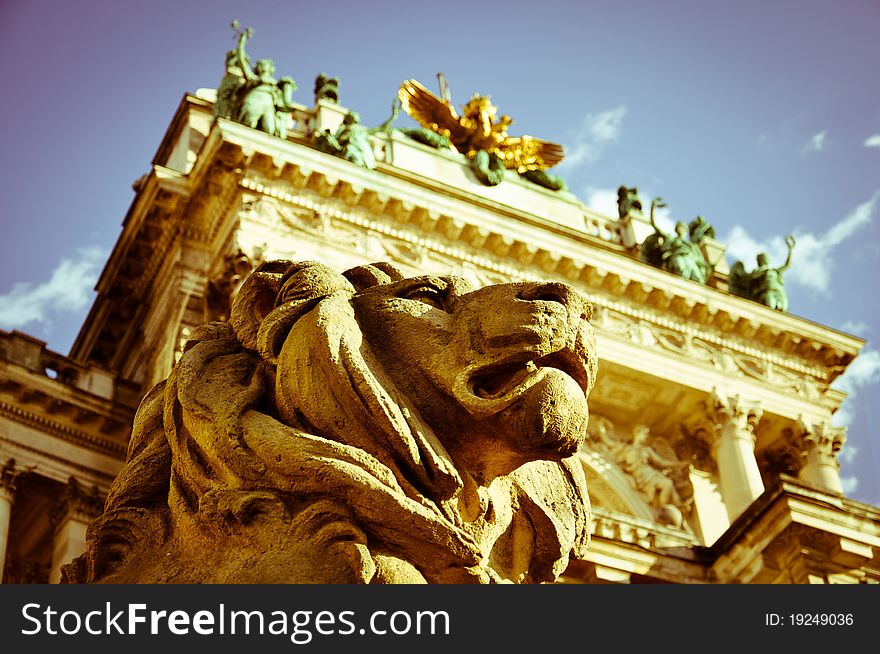 Stone lion sculpture guarding vienna's national library with vintage effects. Stone lion sculpture guarding vienna's national library with vintage effects