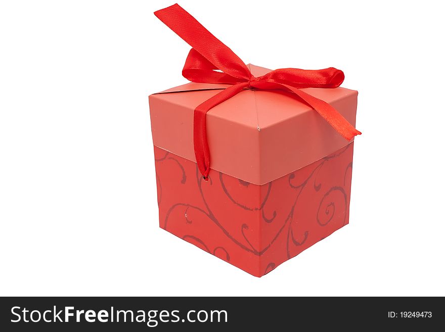 Red gift box with a ribbon on a white background. Red gift box with a ribbon on a white background