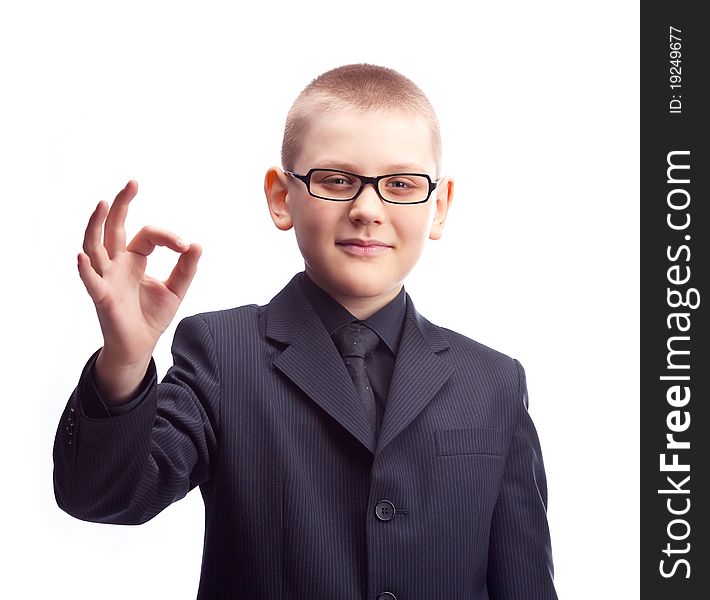 Young ten year old businessman showing the sign OK. Young ten year old businessman showing the sign OK