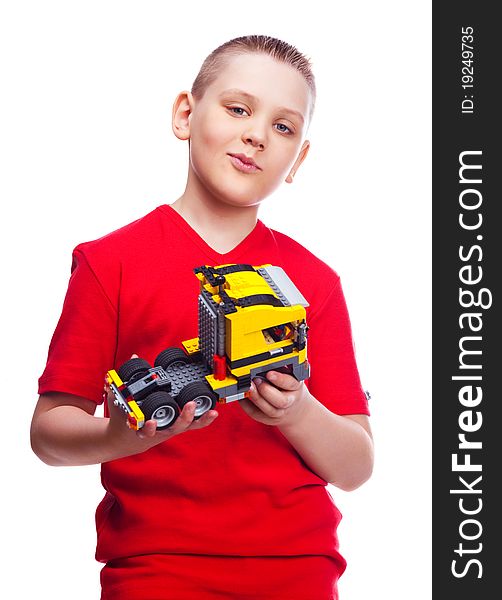 Happy ten year old boy with a toy car, isolated against white. Happy ten year old boy with a toy car, isolated against white