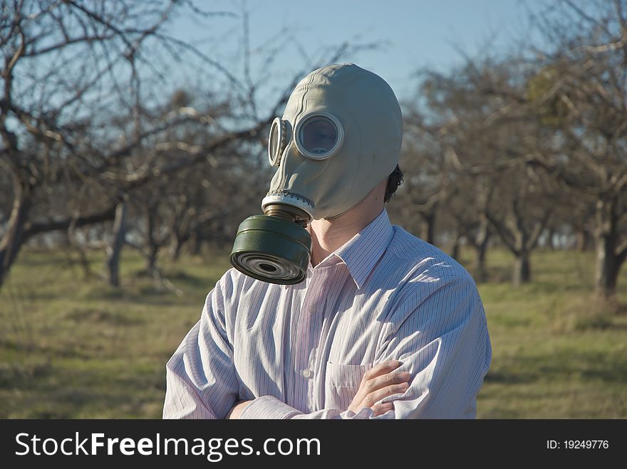 Man in the Gas Mask surrounded by leafless trees.