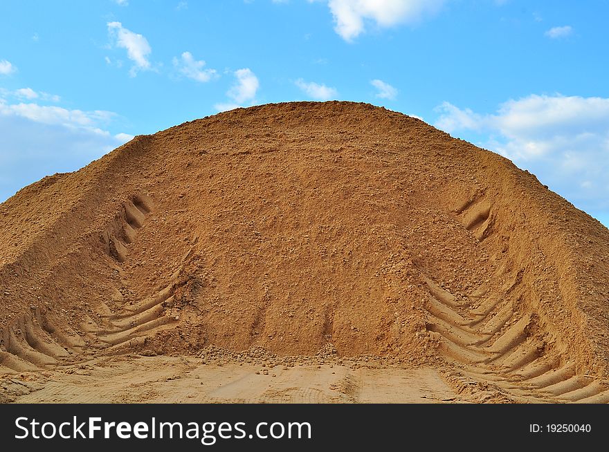 Trace of a bulldozer on a mountain of sand. Trace of a bulldozer on a mountain of sand