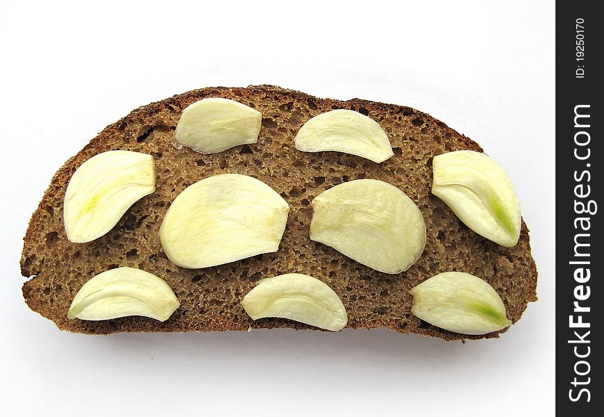 Cut Garlic on brown bread. Cut Garlic on brown bread