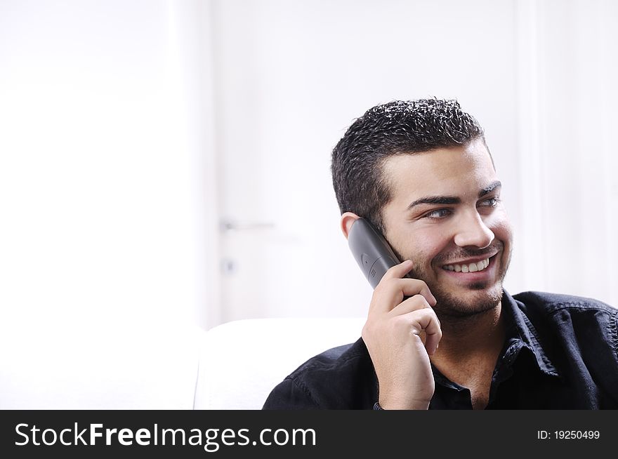 Young Man Using Telephone