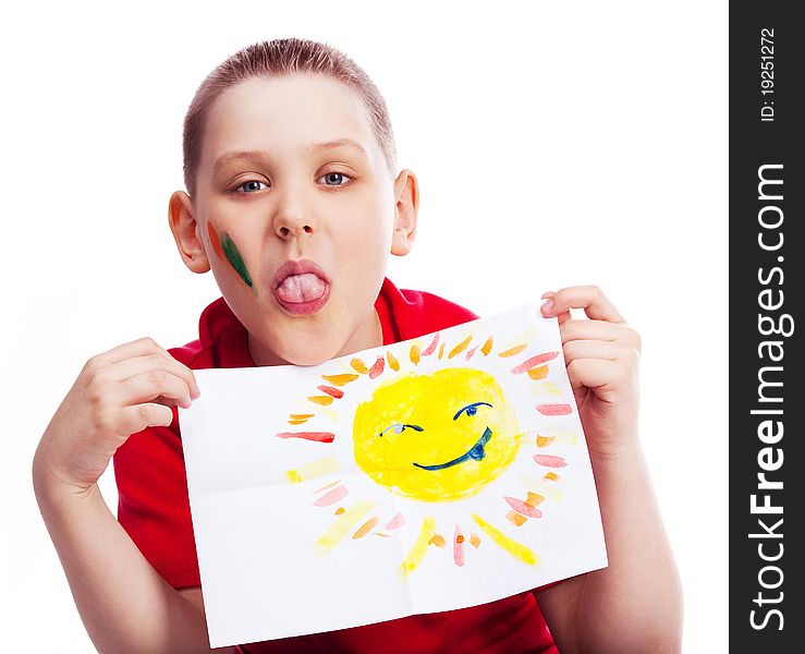 Ten year old boy showing his tongue and holding a watercolor picture of the sun. Ten year old boy showing his tongue and holding a watercolor picture of the sun