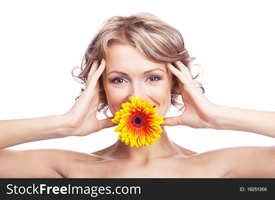 Beautiful young blond curly woman with a flower in her mouth