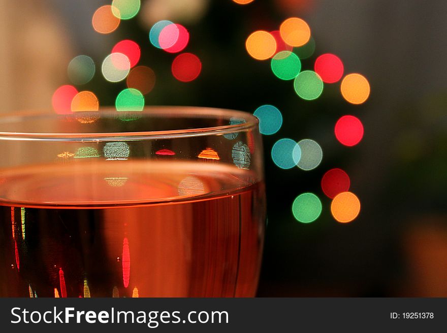 A glass of wine during christmas. A glass of wine during christmas