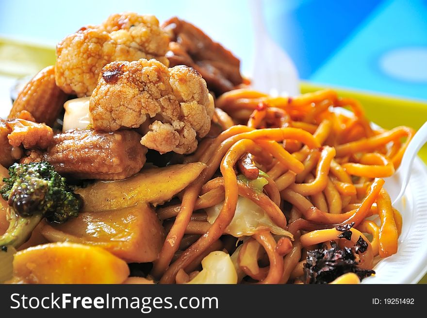Oriental style vegetarian fried noodles topped with healthy vegetables. Oriental style vegetarian fried noodles topped with healthy vegetables.