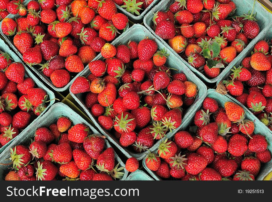 Small cartons of freshly picked red strawberries. Small cartons of freshly picked red strawberries.