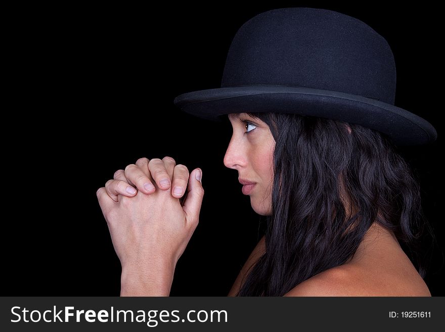 Attractive woman with a hat staring ahead in prayer. Attractive woman with a hat staring ahead in prayer.