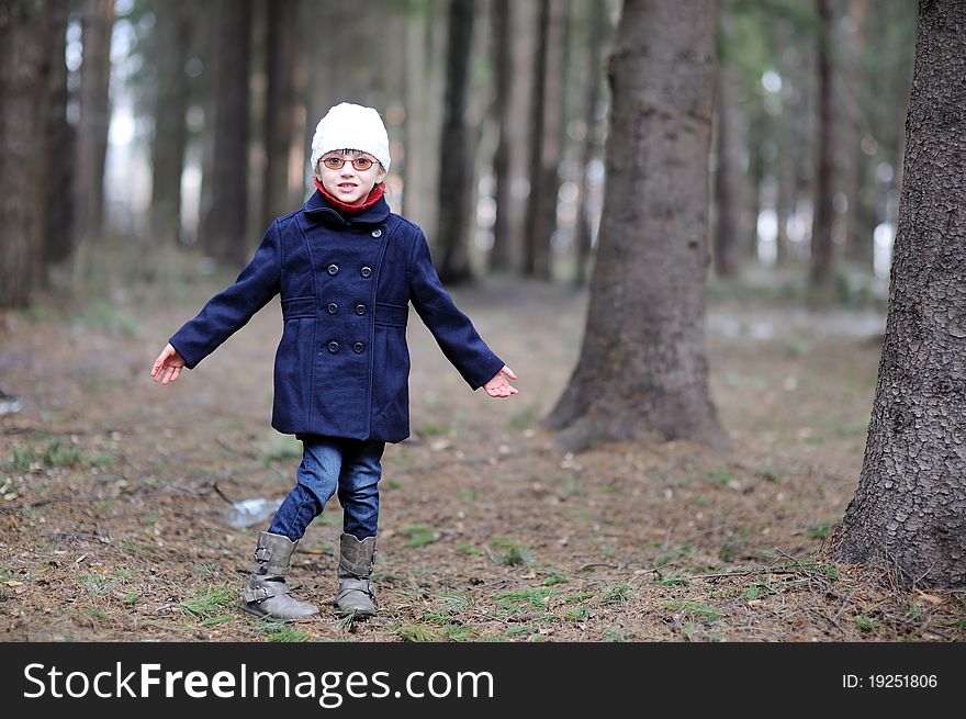 Cute little girl has fun in spring forest