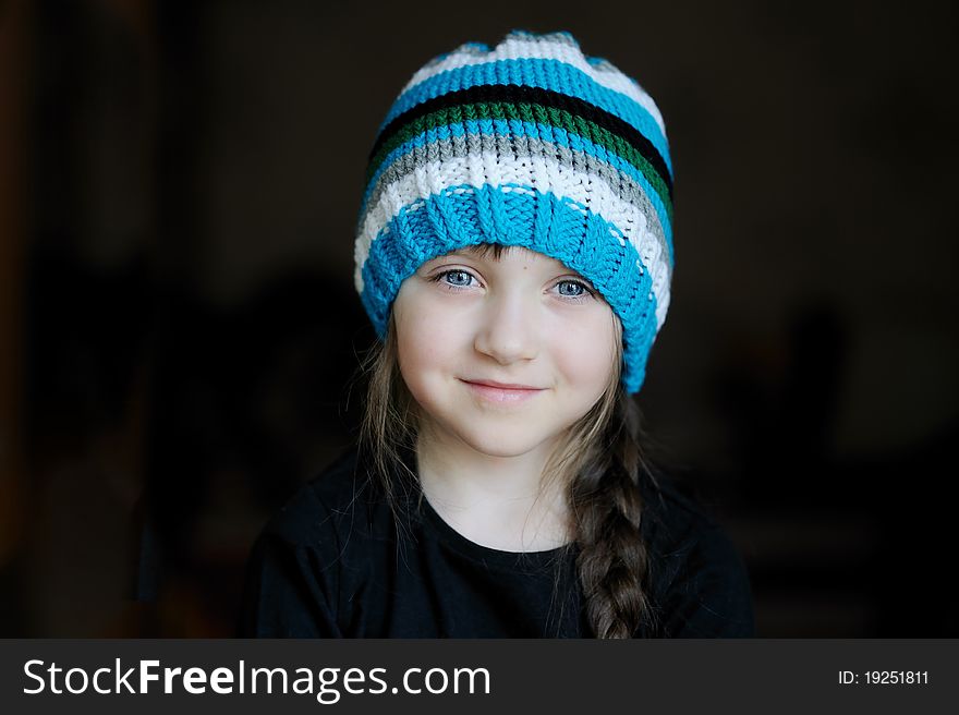 Cutelittle girl in knit blue, grey, white and black stripes on it. Cutelittle girl in knit blue, grey, white and black stripes on it