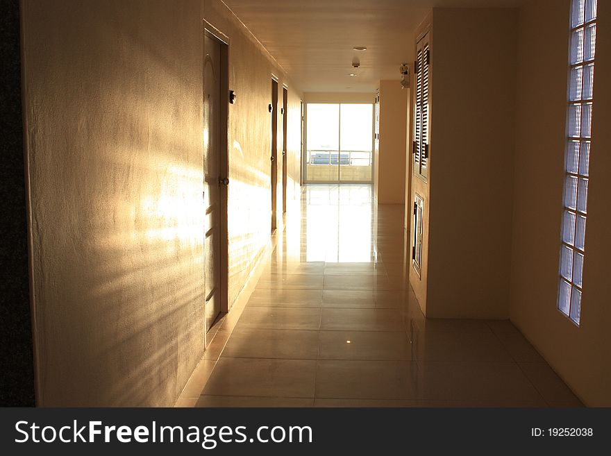 This's way in the apartment near the sea in the morning.The light shine in this area look like the way of light.