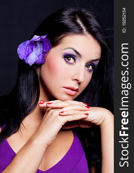 Beautiful young brunette woman with  an orchid in her hair. Beautiful young brunette woman with  an orchid in her hair