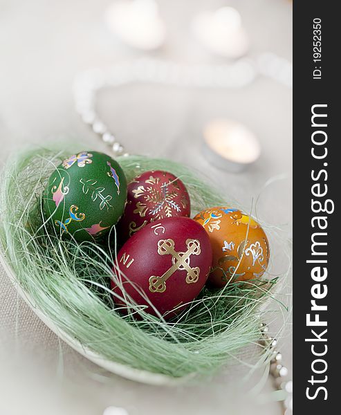 Colored Easter eggs with decoration and candles