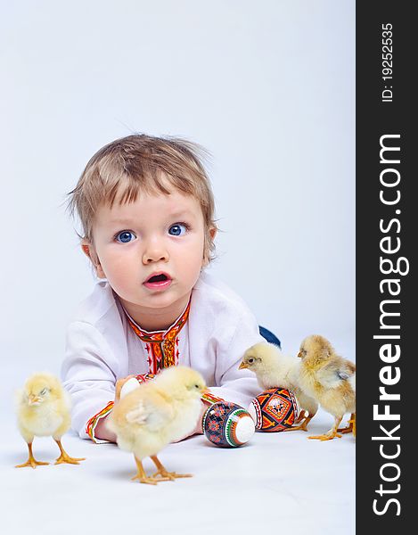 Cute little boy in embroidered with Easter eggs and easter chicks. Cute little boy in embroidered with Easter eggs and easter chicks