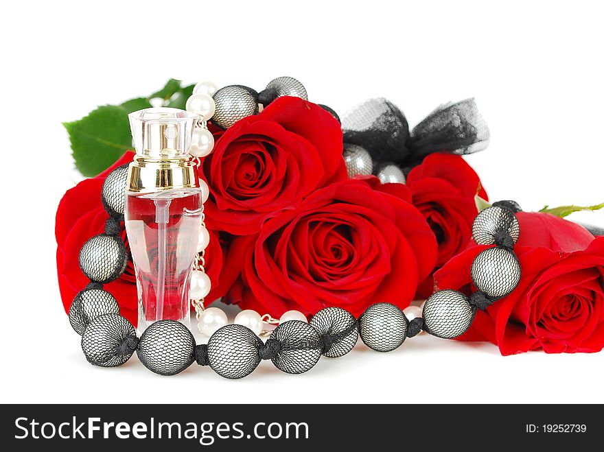 Beautiful red roses and jewelery with perfume with black pearl jewelery isolated on the white. Beautiful red roses and jewelery with perfume with black pearl jewelery isolated on the white.