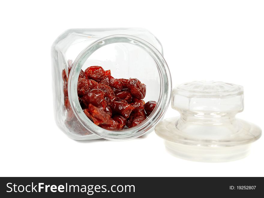 Dry cherry in the glass jar isolated on white background. Dry cherry in the glass jar isolated on white background