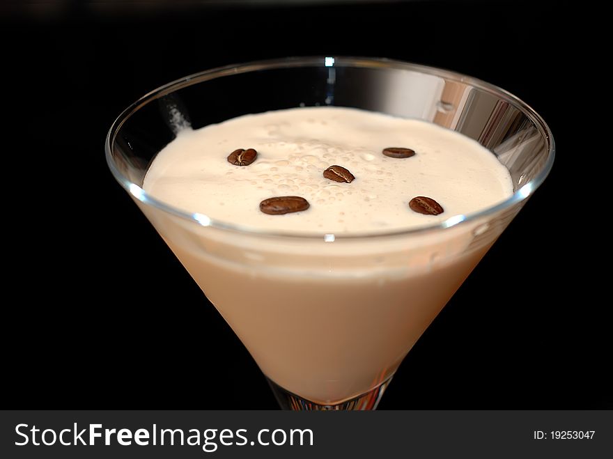 Cocktail in martini glasses on bar background with coffe beans