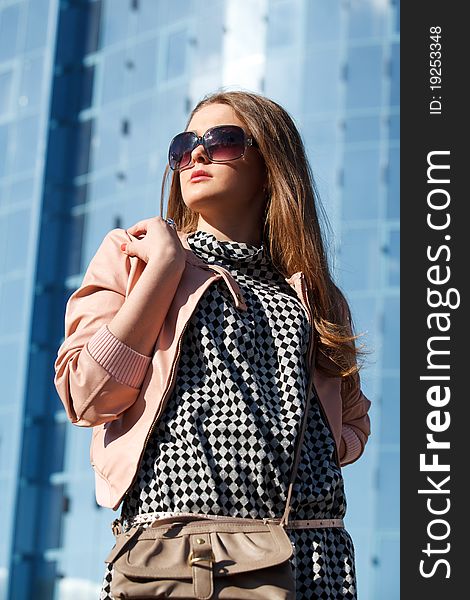 Business girl stay in front of modern business offices center