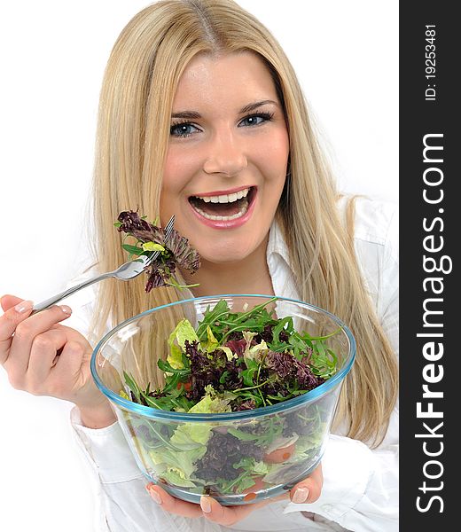 Pretty woman eating green vegetable salad.