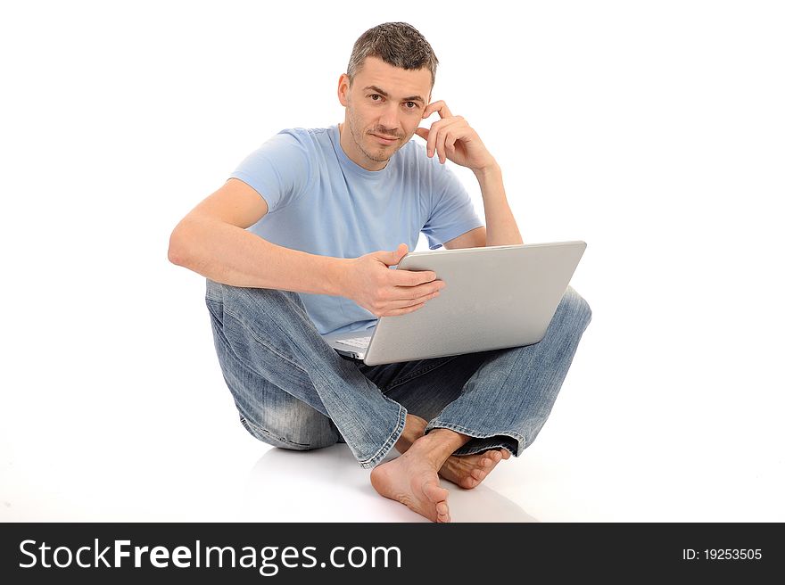 Handsome young male working on laptop computer. isolated