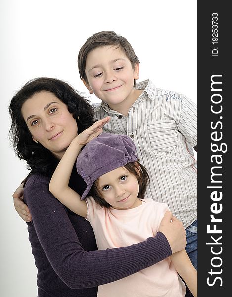 Beautiful mother and her children posing in studio. Beautiful mother and her children posing in studio