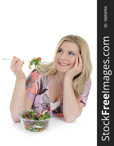 Pretty woman eating green vegetable salad. isolated on white