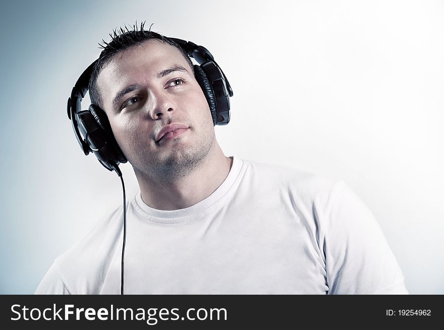 Young boy listening music in headphones isolated