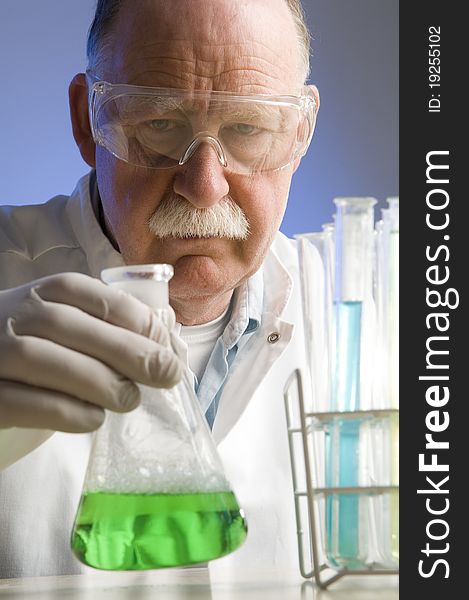 Chemist looking closely at his latest discovery. Chemist looking closely at his latest discovery