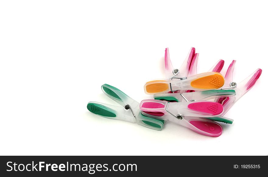Colorful clothes-pegs on a white background. Colorful clothes-pegs on a white background