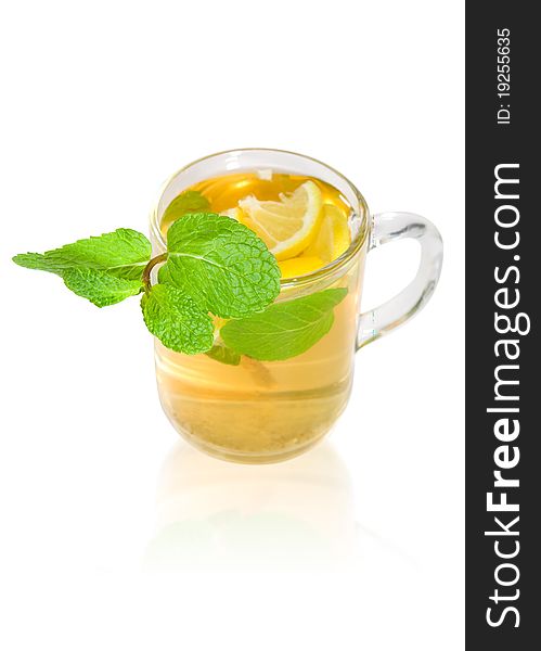 Green tea with lemon and mint in a transparent mug