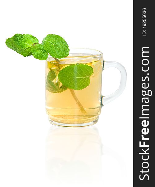 Green tea with lemon and mint in a transparent mug