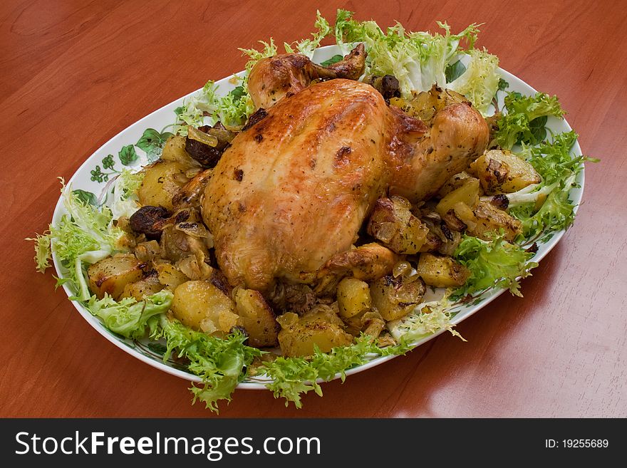 A dish of chicken with salad on the kitchen table. A dish of chicken with salad on the kitchen table