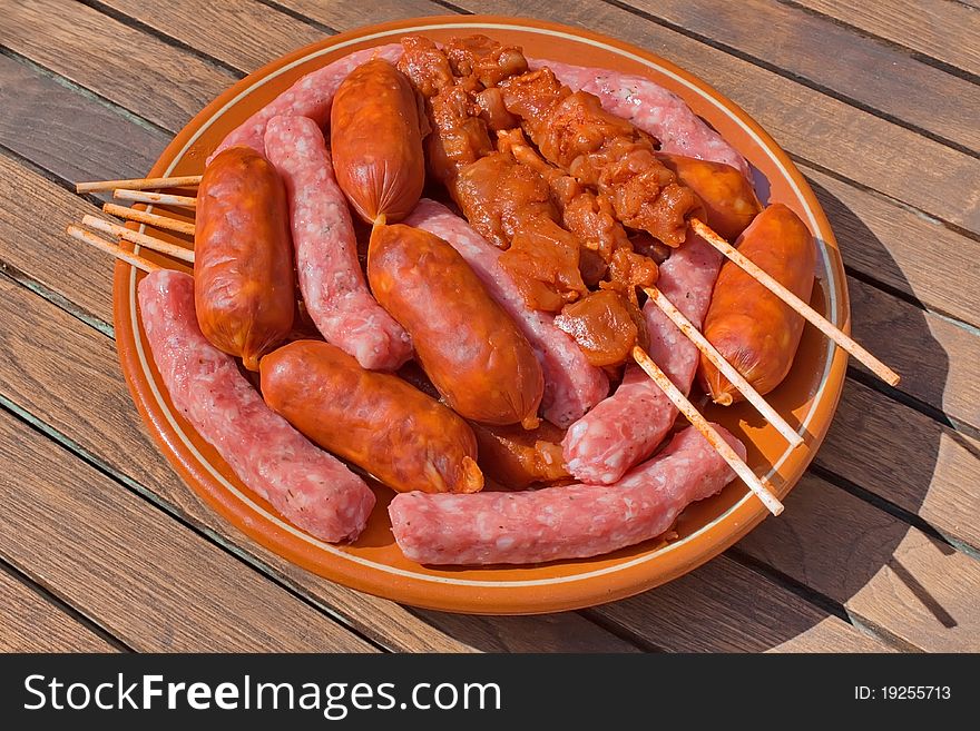 Assorted meat prepared for cooking on the grill on a summer day. Assorted meat prepared for cooking on the grill on a summer day