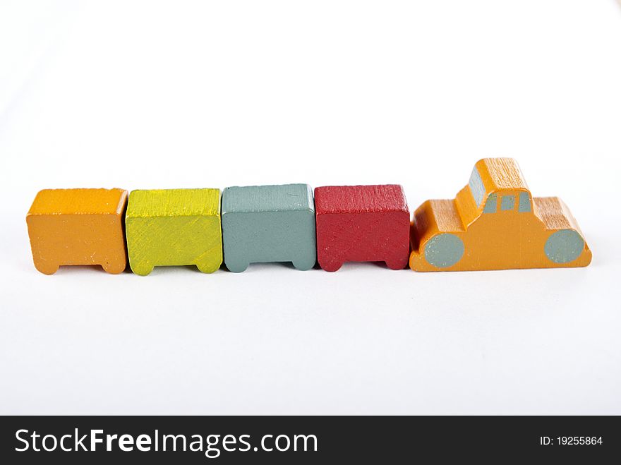 Some wooden toy cars on white