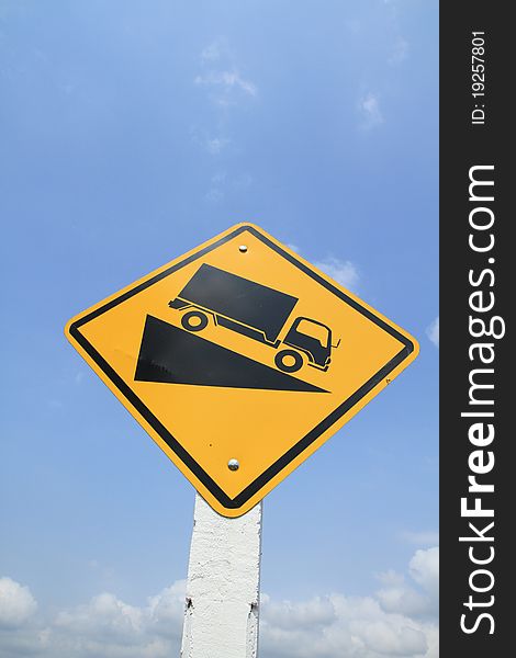 Downhill truck sign on blue sky background