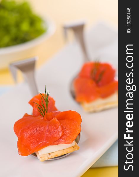 Appetizer smoked salmon with cream cheese and salad in the background. Very shallow depth of field. Appetizer smoked salmon with cream cheese and salad in the background. Very shallow depth of field.