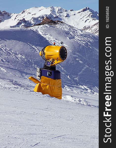 Snow cannon on the mountains background