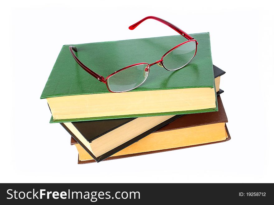 Old books and glasses on a white background. Old books and glasses on a white background