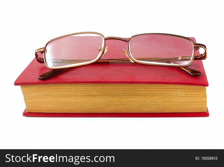 Red book and glasses on a white background. Red book and glasses on a white background