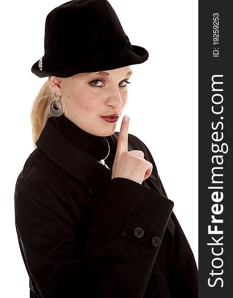 A beautiful girl in her black hat and over coat with a secret .