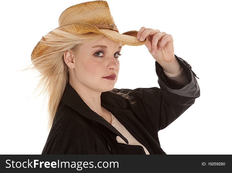 A beautiful cowgirl in her jacket and cowboy hat with a serious expression on her face. A beautiful cowgirl in her jacket and cowboy hat with a serious expression on her face.