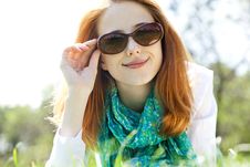 Red-haired Girl In Sunglasses At The Park. Royalty Free Stock Photos Red-haired Girl In Sunglasses At The Park. Royalty Free Stock Photos